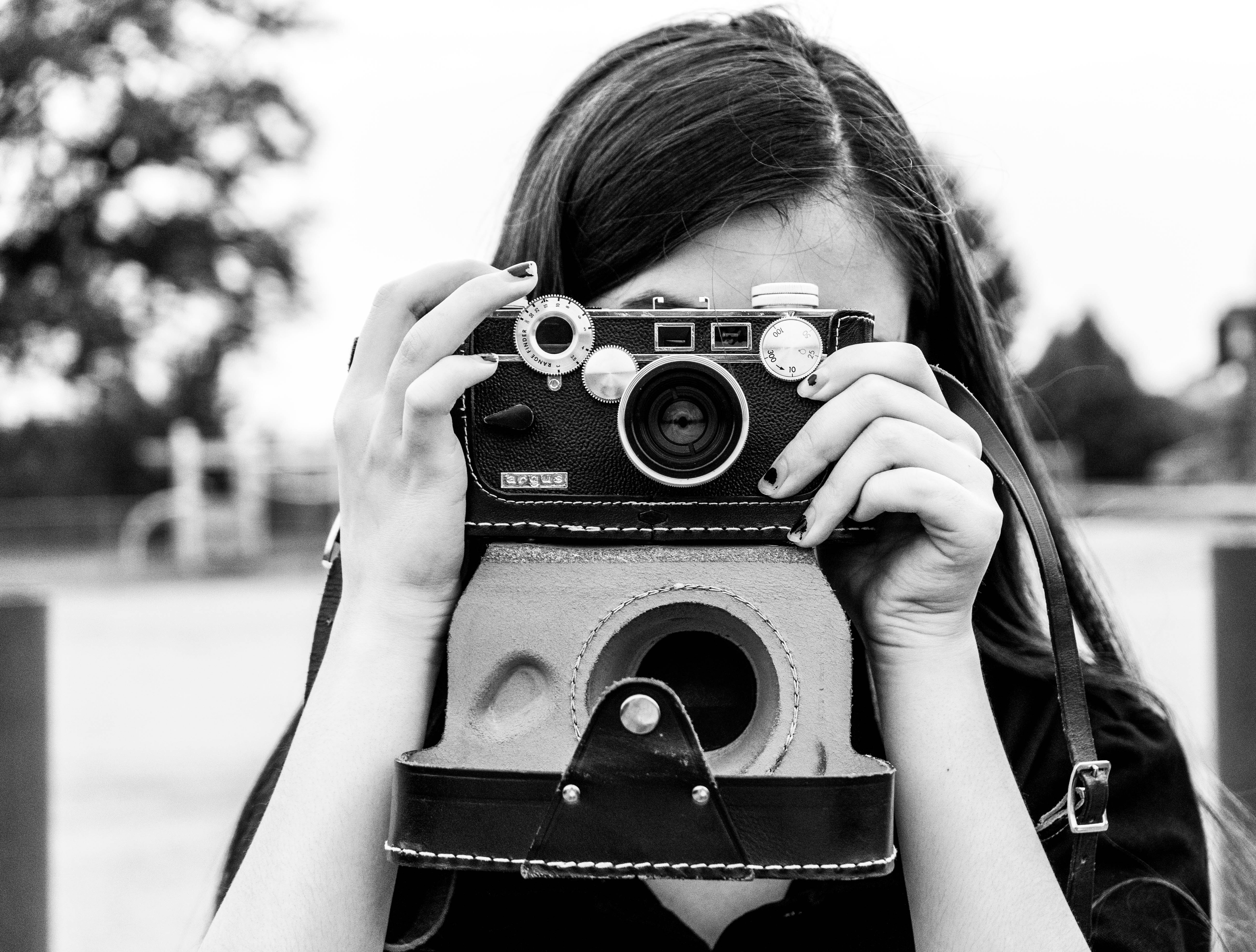 Photographer looking through a vintage camera